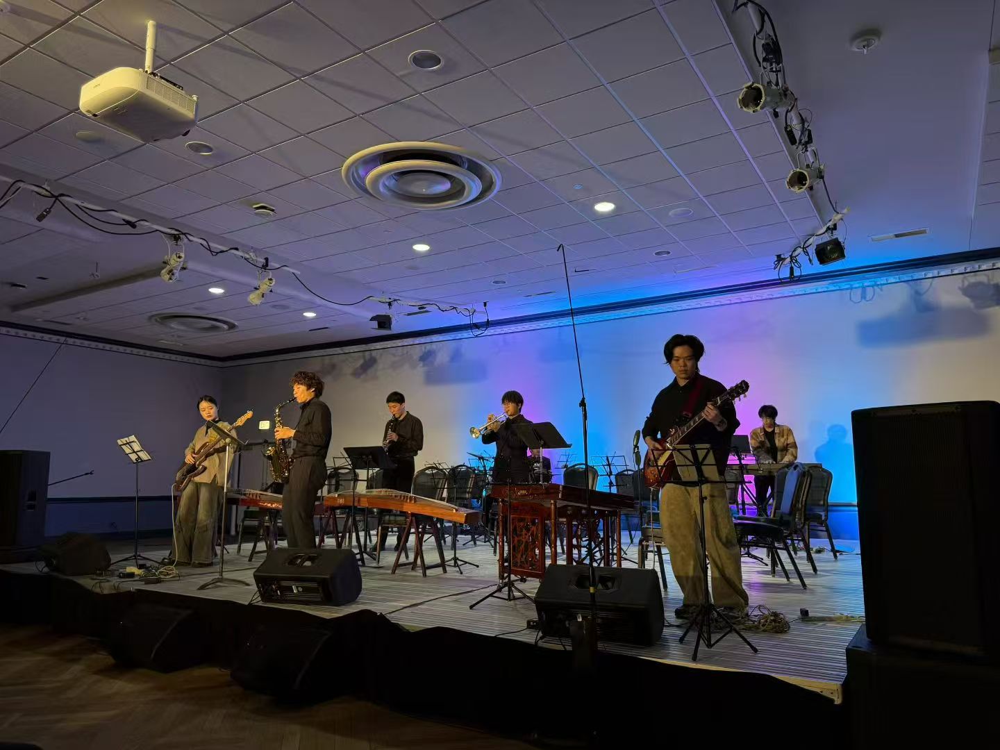Band performing on a wide stage