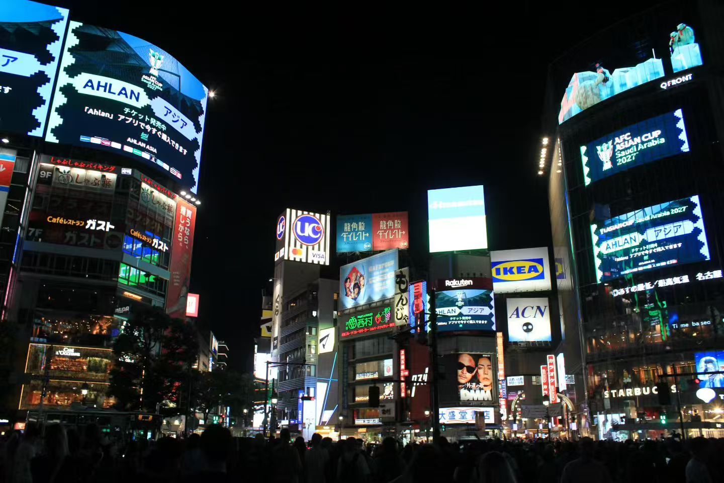 Illuminated city crossing in Tokyo at night